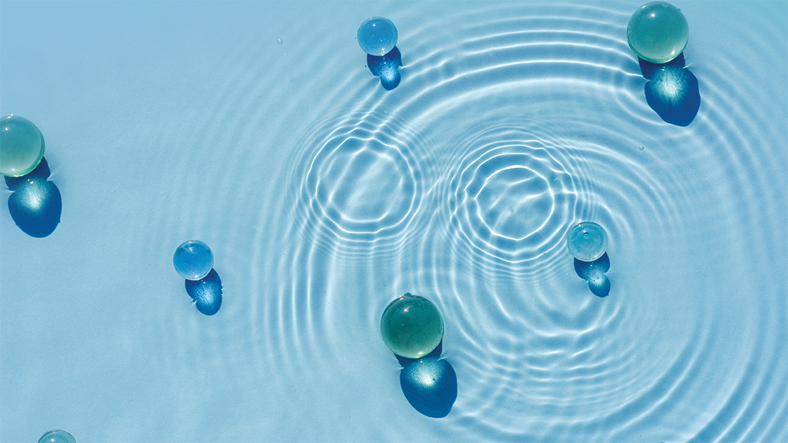 Bubbles and ripples on the surface of blue water 