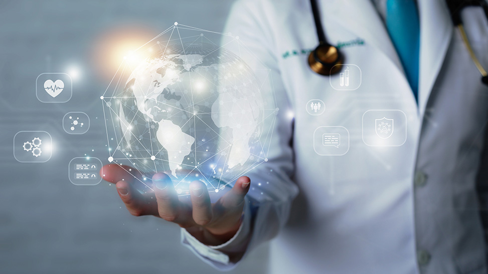 A hologram of the Earth with digital icons hovering around it appears above the outstretched hand of a person in a labcoat